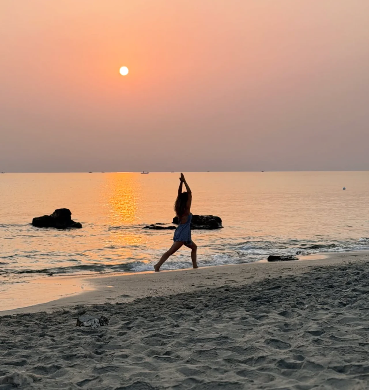 Una pratica yoga sulla spiaggia, nella luce morbida del tramonto